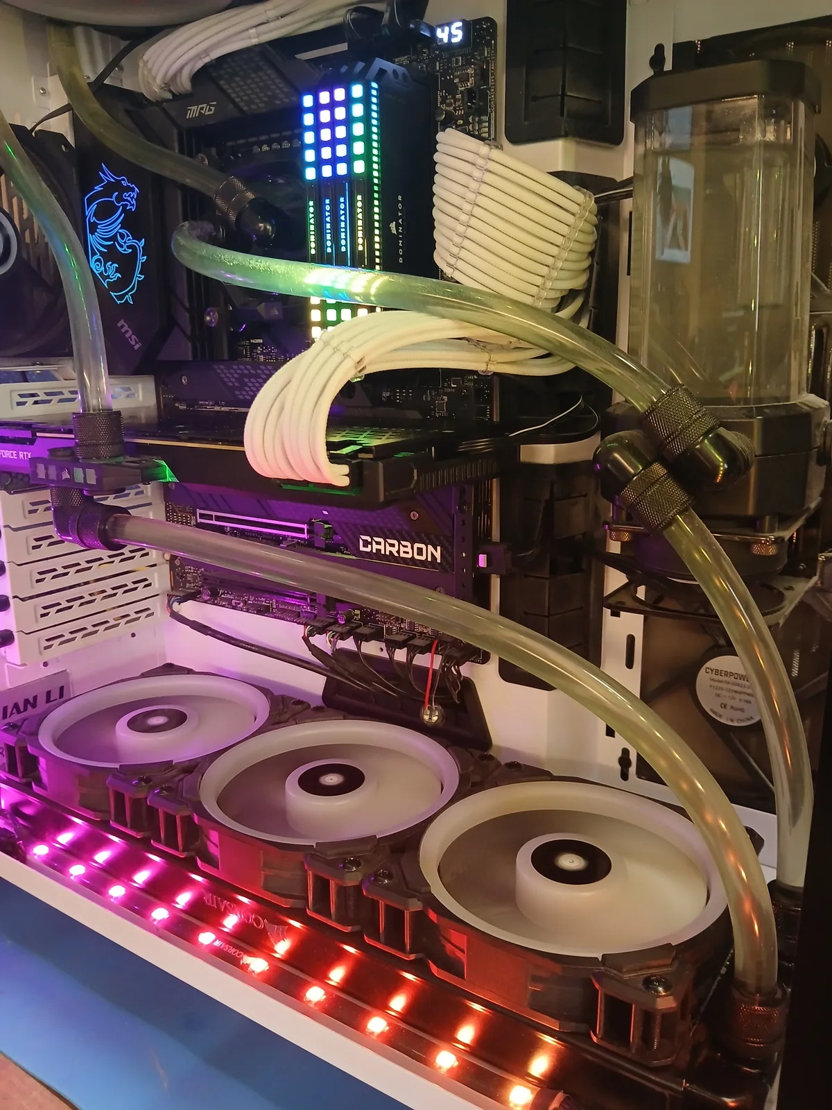 Top-down view of the same custom water-cooled rig showing the reservoir and clear coolant tubing after a fresh fill